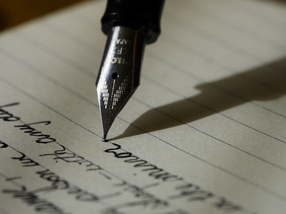 Open notebook with handwritten daily plan on a wooden desk